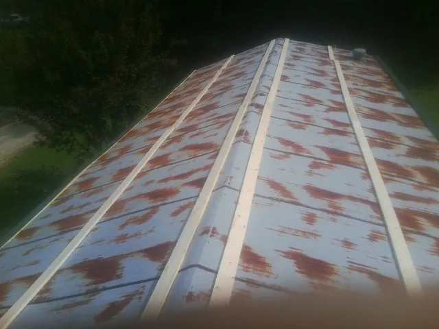 Rusted metal roof panels with new wood purlins before replacement — Storm Damage Roof Repair in Berry Creek by Roofing Brothers